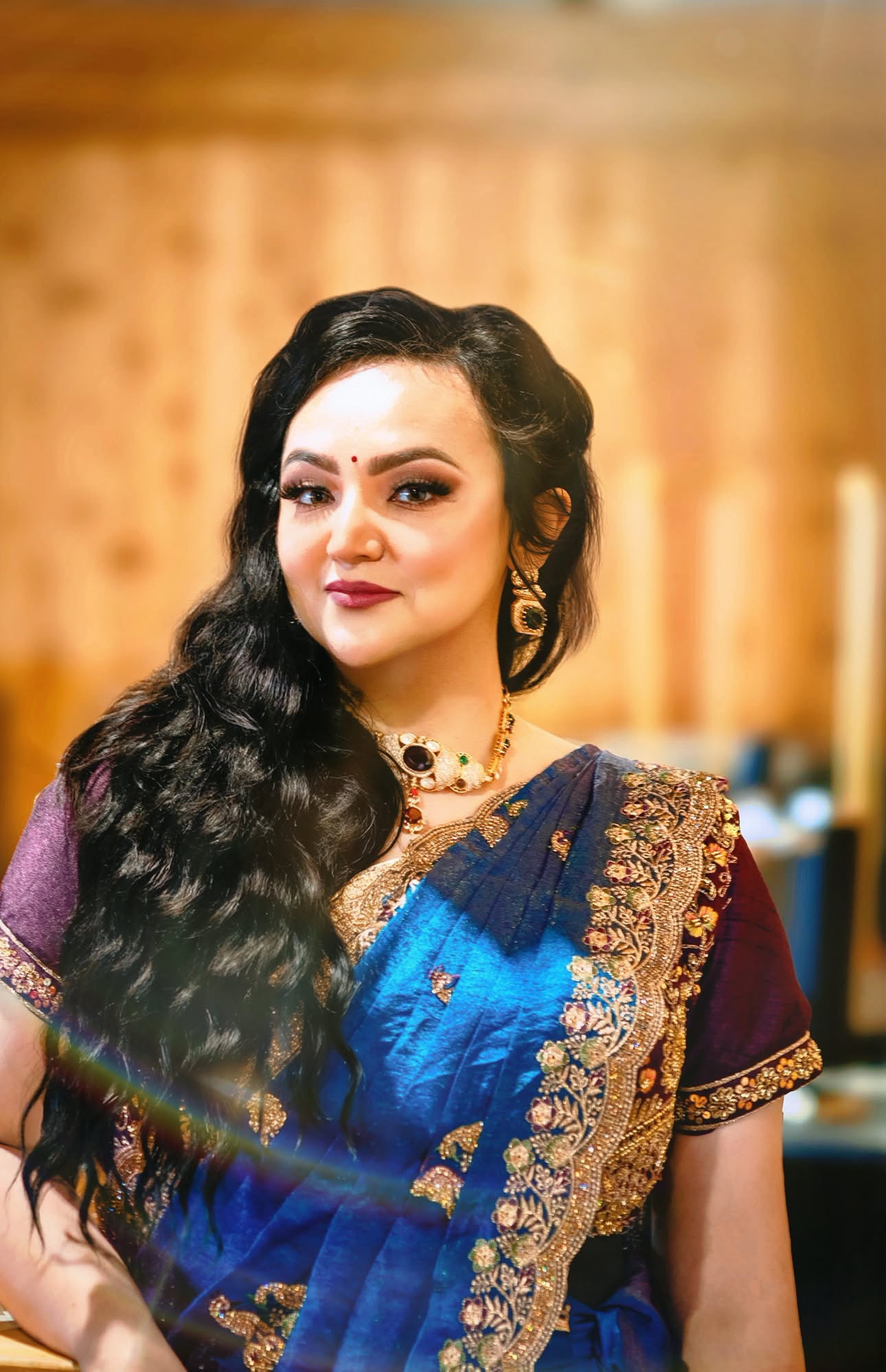 Sapphire silk saree with gold zari borders in soft indoor light — Vetri Frames, VA & the DMV