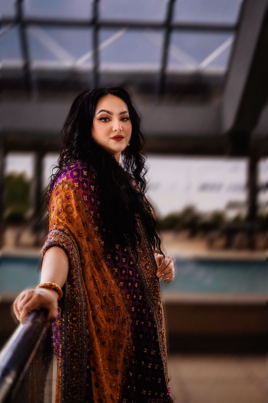 Poolside fashion portrait in an embroidered ochre and purple dupatta at dusk — Virginia