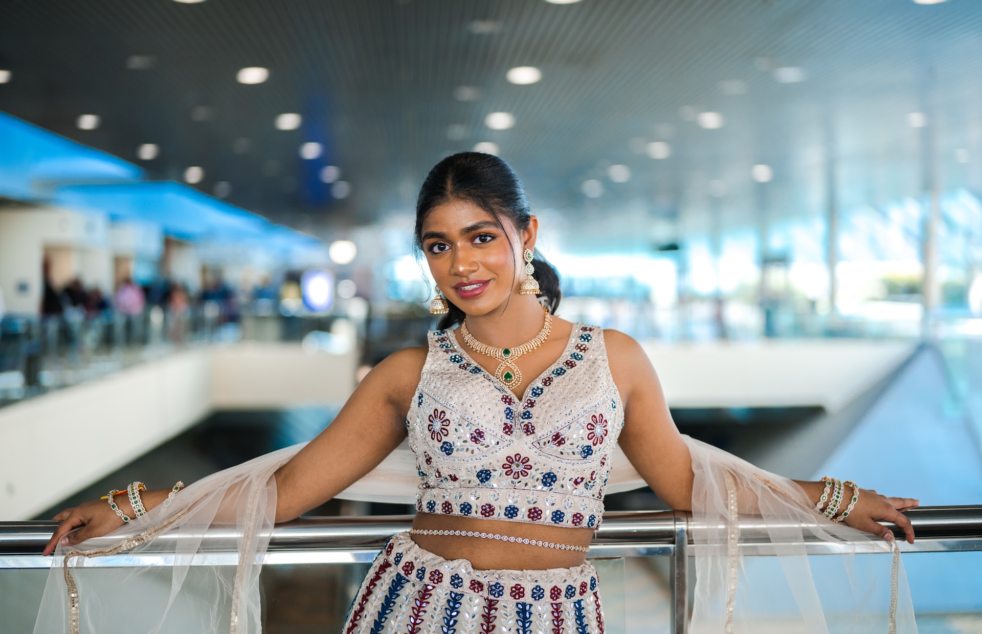 Ivory mirror-work lehenga at a sunlit railing — DMV fashion photographer Vetri Frames