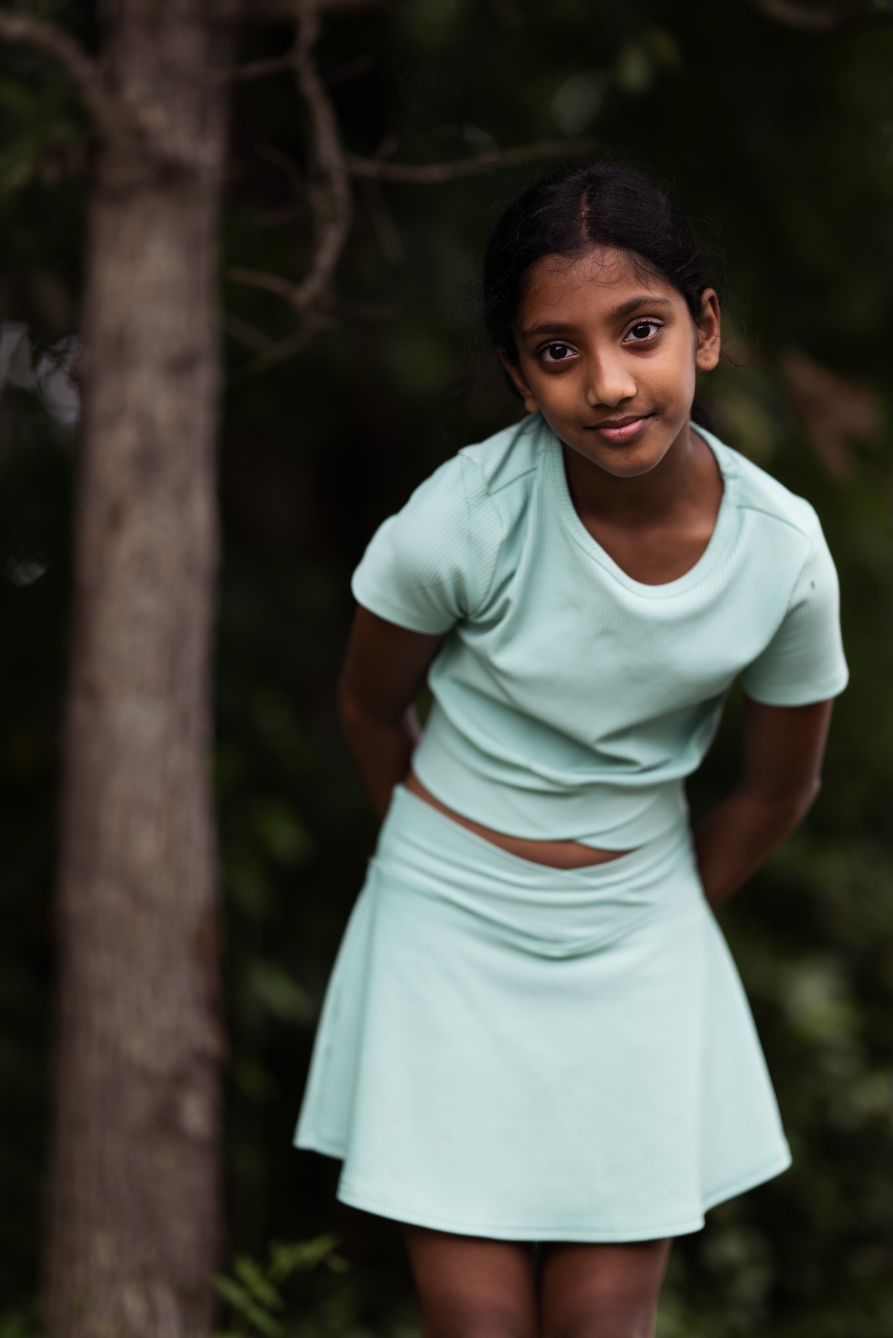 Woodland portrait of a girl in a mint set against dark greenery — DMV portrait photographer